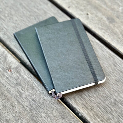 two pocket moleskine notebooks, sketchbook and journal